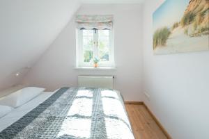 Tempat tidur dalam kamar di Reethüs Brodersen