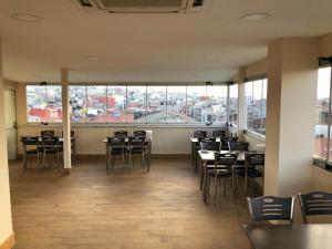 a restaurant with chairs and tables and a large window at BIG MOLLS HOTEL in Istanbul