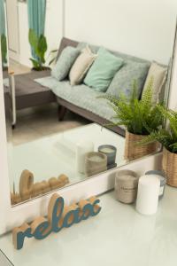 a living room with a couch and a mirror at ''Meraviglia casa'' Ariadne in Kato Daratso