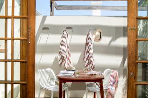 a table and chairs with candy canes on a balcony at Stone Cottages in Cape Town