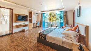 a bedroom with a large bed and a large window at Season Paradise in Thulusdhoo