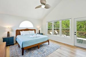 a bedroom with a bed and a ceiling fan at 307 W Indian - The Prickly Pear in Folly Beach