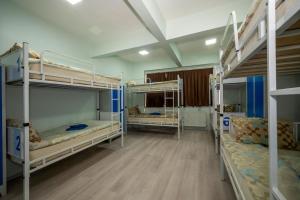A bed or beds in a room at XALİLA HOSTEL & CAFE LADİES ROOM