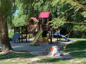 a park with a playground with a slide at László Nyaralóház in Balatonfenyves