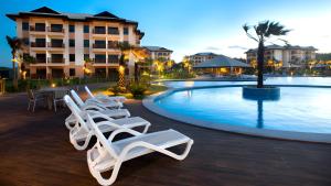 - un groupe de chaises longues à côté de la piscine dans l'établissement VG-Sun Deluxe Bungalow Cumbuco Beach View Top WiFi, à Cumbuco