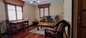 a living room with a couch and a table at Apartamentos El Sol in Potes