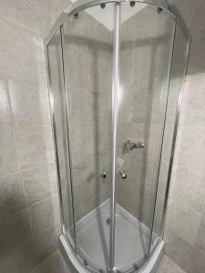 a shower with a glass enclosure in a bathroom at Lelle Centrum Vendégház in Balatonlelle