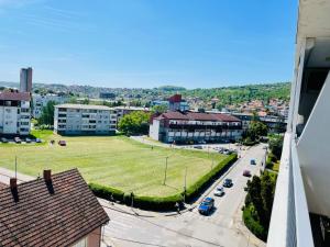 arial view of a city with a green field at Apartman M&M in Doboj