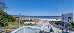 a view of the beach from the balcony of a building at CENTRAL APARTAMENT La malul marii 3 camere & Living in Mangalia