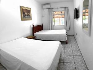 Un pat sau paturi într-o cameră la CASA COMPLETA para alugar na Praia da Pinheira.