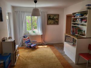 a small room with a chair and a window at Family's Nest Chiemsee in Chieming
