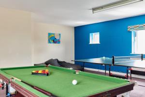 a room with a pool table and ping pong balls at Finest Retreats - Willow Barn in Ashbourne