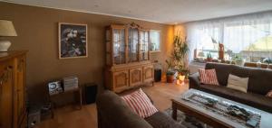 a living room with a couch and a table at Ferienwohnung Am Waldrand in Bad Driburg