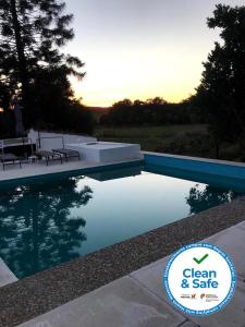 a swimming pool with a sign that says clean and safe at Horta de Pepinais in Elvas