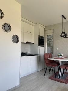 a kitchen and dining room with a table and chairs at VIP APARTMAN 2020 in Vrnjačka Banja