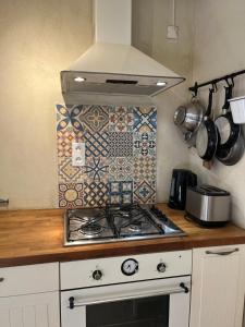 a kitchen with a stove top oven in a kitchen at Maison de Charme dans Domaine 17ème in Tarascon +29 photos
