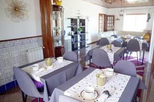 a dining room with tables and chairs in a restaurant at De frente para o Mar in Costa Nova