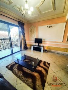 a living room with a couch and a table at LAUNAPARK RESIDENCE in Douala