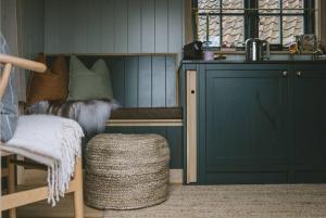 a room with a bench and a chair and a sink at Island Hut - Outdoor bath tub, firepit and water equipment in Saltford