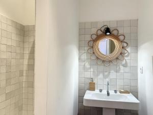 a bathroom with a sink and a mirror at Résidence Eole in Cargèse