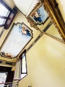 a room with paintings on the ceilings and windows at South Garda Suites in Desenzano del Garda