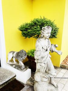 a statue of a girl with a dog and a plant at South Garda Suites in Desenzano del Garda