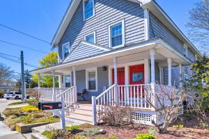 a house with a red door and a white porch at Mystic Refuge with Patio Less Than 1 Mi to Downtown! in Mystic