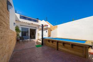 a swimming pool on the side of a building at HomeHolidaysRentals Benoit - Costa Barcelona in Pineda de Mar