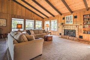 a living room with a couch and a fireplace at Calm Groveland Cabin - Near Pine Mountain Lake! in Groveland
