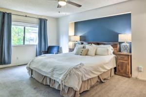 a bedroom with a large bed with a blue wall at Calm Groveland Cabin - Near Pine Mountain Lake! in Groveland