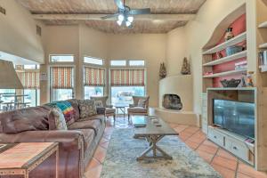a living room with a couch and a tv at Community Pool Pueblo Home Near Downtown Mesa in Mesa