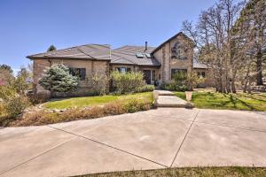 a house with a driveway in front of it at Luxe Garden-Level Apartment with Sauna and Gym! in Colorado Springs