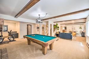 a living room with a pool table in it at Luxe Garden-Level Apartment with Sauna and Gym! in Colorado Springs