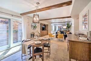 a kitchen and living room with a table and a dining room at Luxe Garden-Level Apartment with Sauna and Gym! in Colorado Springs