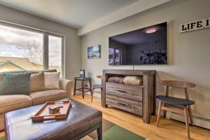 a living room with a couch and a bed and a mirror at Cozy Montana Condo with Walk to Big Sky Resort! in Big Sky