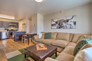 a living room with a couch and a table at Cozy Montana Condo with Walk to Big Sky Resort! in Big Sky
