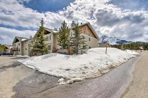 a pile of snow in front of a house at Cozy Montana Condo with Walk to Big Sky Resort! in Big Sky