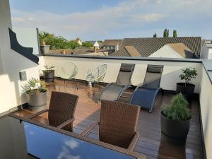 balkon z krzesłami i roślinami na dachu w obiekcie PENTHOUSE Griemann 1 mit Infrarotkabine und eigener Dachterrasse für max 4 Personen w mieście Illmitz