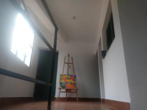 a room with a ladder and a painting on the wall at EL HOSTELITO in Iruya