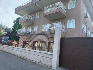 a building with balconies on the side of it at Apartamentos Sanjuan in Porriño