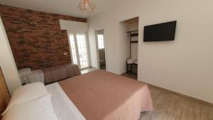 a bedroom with a bed and a brick wall at La Resilienza in Ginosa Marina