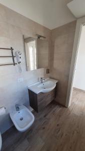a bathroom with a sink and a toilet at La Resilienza in Ginosa Marina