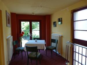 a dining room with a white table and chairs at Waldhaus Colditz Garni in Colditz