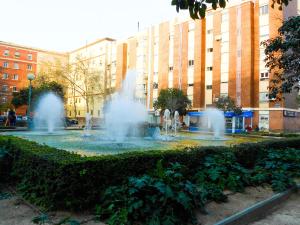a fountain with two fountains in front of buildings at Private Apartment Horticultor Bosch in Valencia