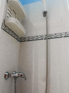 a shower with a shower head in a bathroom at Private Apartment Horticultor Bosch in Valencia