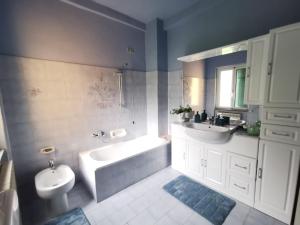 a bathroom with a tub and a sink and a toilet at Itaca in Varazze +66 photos