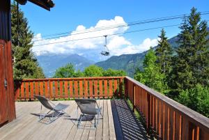 a deck with two chairs and a ski lift at CHALET REROLLE in Doucy