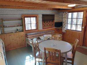a dining room with a table and chairs at Takalahti Lodge in Puumala