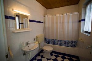 a bathroom with a toilet and a sink at Rooms Roza in Slunj