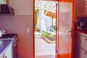 a kitchen with an open door to a patio at Sea Frame in Skiathos